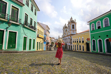 Visiting Salvador de Bahia, Brazil. Rear view of young tourist woman in the famous Pelourinho...