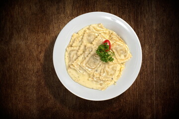Bufala mozzarella ravioli with Alfredo sauce on plate