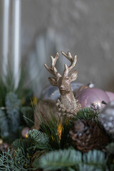 Christmas gold Deer figure. Home decoration, nobilis, pine needles Christmas composition with beautiful decoration. Festive Decor, Christmas Decor.