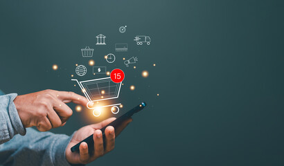 Online shopping and e-commerce technology concept, Businessman using smartphone with shopping cart and business icons. Buying or selling products over the internet network. Home delivery services.