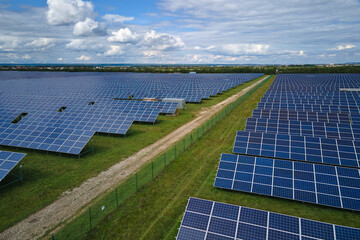 Fototapeta na wymiar Aerial view of large sustainable electrical power plant with rows of solar photovoltaic panels for producing clean electric energy. Concept of renewable electricity with zero emission
