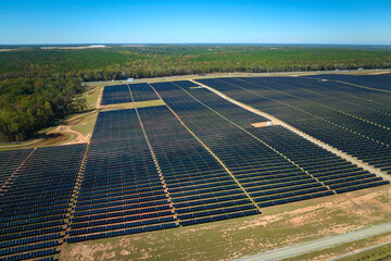 Aerial view of large sustainable electrical power plant with rows of solar photovoltaic panels for producing clean electric energy. Concept of renewable electricity with zero emission