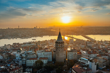 Obraz premium Galata Tower. Aerial view of Galata Tower at sunset. Golden Horn Metro Bridge are in the background. A unique view of Istanbul.