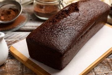 Tasty chocolate sponge cake on wooden table, closeup