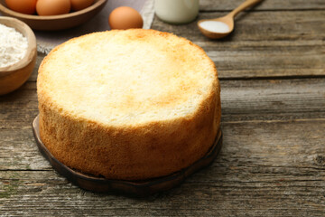 Tasty fresh sponge cake on wooden table