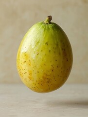 A Single Yellow and Green Fruit with a Stem