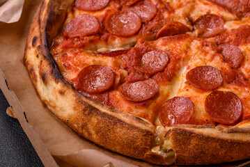Pepperoni pizza with sausage, mozzarella cheese, tomatoes, salt and spices