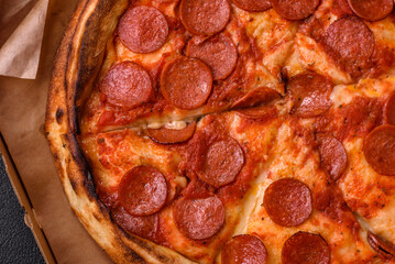 Pepperoni pizza with sausage, mozzarella cheese, tomatoes, salt and spices