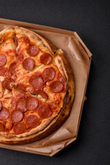 Pepperoni pizza with sausage, mozzarella cheese, tomatoes, salt and spices