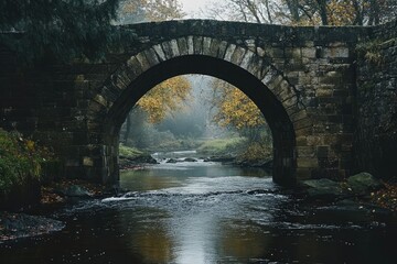Stone Arch Bridge Over Flowing Creek in Autumn Forest