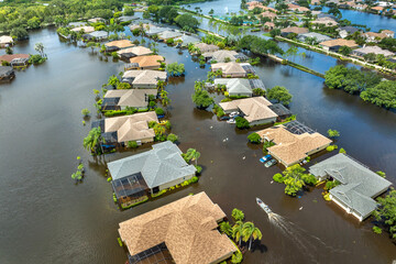 Hurricane Debby flooded street in Sarasota, Florida. Victims boating on rainfall flood waters...