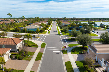 Premium housing development in the USA. Expensive houses between green palm trees in southwest Florida