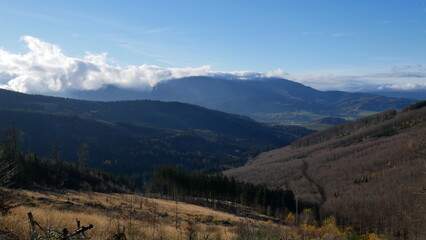 Scenic autumn landscape with clouds rolling over a mountain range of Jeseniky mountains, Czech Republic