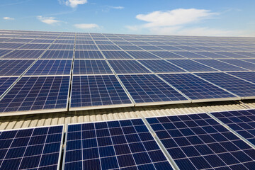 Solar photovoltaic panels installed on building roof for producing clean ecological electric energy. Renewable electricity with zero emission concept