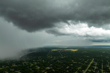 Tropical thunderstorm precipitation falling down on Florida town. Rain shower in summer