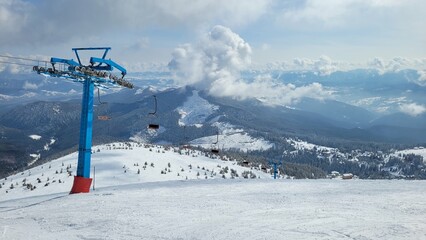 winter mountain landscape with ski resort. View of the ski lift on the top of the mountain