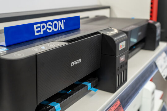 Epson printer on a shelf in an electronics and computer store. Epson logo on a printer close-up. Minsk, Belarus - November 6, 2024