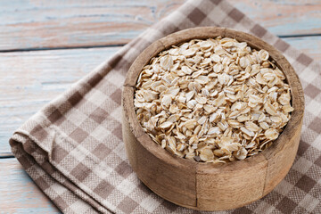Oatmeal in Wooden Bowl on Old Boards, Copy Space
