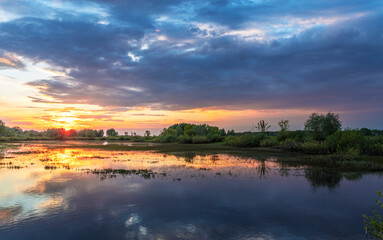 Calm lake with a beautiful sunset in the background
