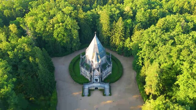 Discover the stunning Schwarzenberg tomb surrounded by lush greenery in Domanin, near Trebon, Czechia, showcasing its unique architecture and serene setting.