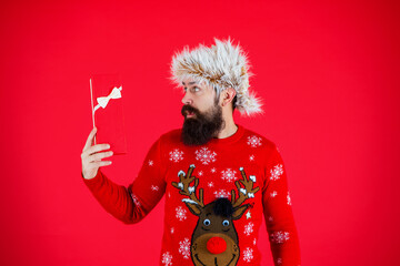 Xmas present and gift. Winter shopping sale. New Year and Christmas. Xmas holiday present. Man at New Year sale. Man hold holiday shopping gift from Santa in studio