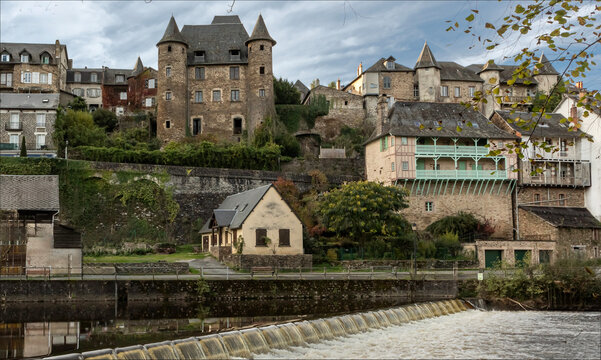 Historic fortified town with history dating back to Roman times above a river with a weir across