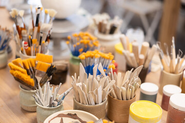 Close-up of brushes and tools for making ceramics in ceramic workshop