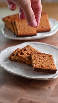 Traditional Swiss spiced bread, Biberfladen, sliced and served on plates. This aromatic bread, filled with honey and nuts, offers a cozy, festive feel, perfect for winter holiday promotions, social