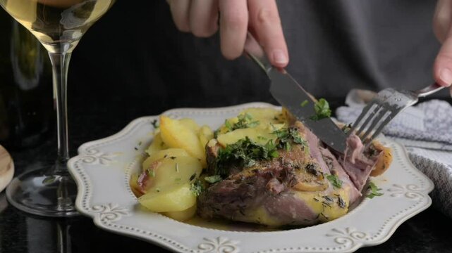 Roasted Duck Leg with Herbs and White Wine Gourmet Dining Experience. Succulent roasted duck leg seasoned with fresh herbs and paired with potatoes, served alongside a glass of white wine. 