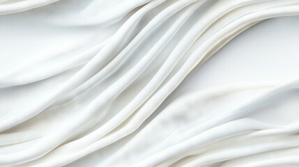   A close-up of a white cloth with wavy designs on the top and bottom edges, as well as the lower part of the fabric