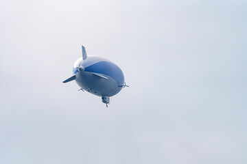 An airship in the sky with people on an excursion above the earth in a tourist flight. © andov