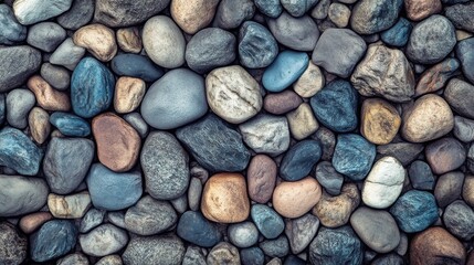 Colorful assortment of smooth pebbles in various shades and textures, creating a natural mosaic.