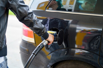 Refueling a car at a petrol filling station. © andov