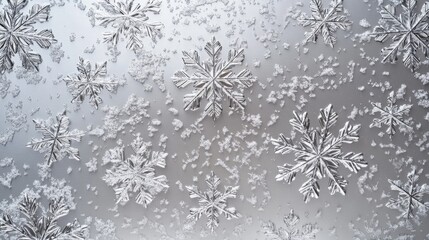 Delicate snowflakes scattered gracefully on a soft gray background, capturing the beauty of winter's charm.