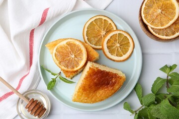 Tasty semolina cake served on white tiled table, flat lay