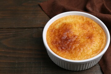 Tasty semolina cake served on wooden table, closeup. Space for text