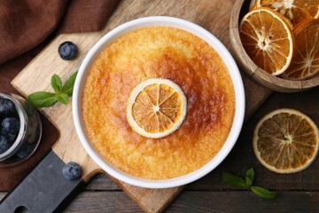 Tasty semolina cake served on wooden table, flat lay