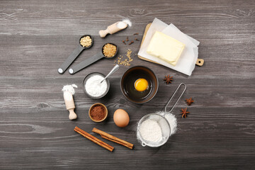Baking powder and other products on grey wooden table, flat lay