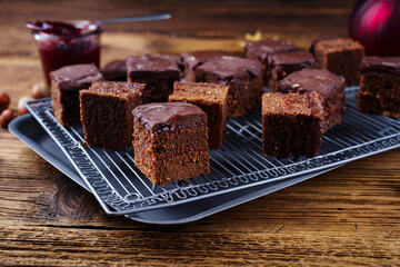 Homemade fudgy brownies domino cake pastry cubes with marmalade and dark chocolate topping glaze...