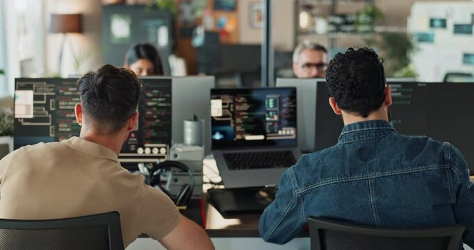 Coding, computer screen and fist bump with business people in office together from back. Celebration, success and web development with happy programmer team reading machine language in workplace