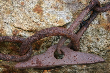 Rusted chain on rock. 