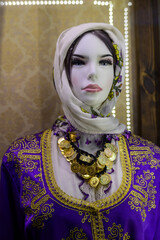 This elegant mannequin displays exquisite traditional clothing adorned with vibrant embroidery and stunning jewelry