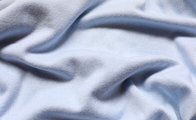 Fototapeta premium Woolen fabric of light blue color. Soft fine knitting.