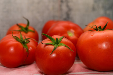 Freshly harvested red tomatoes arranged on a textured background with a hint of rustic charm