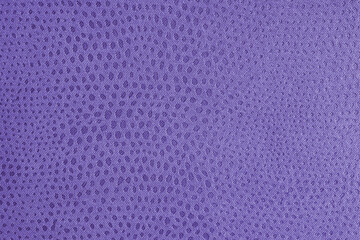 Cloth structure of jacquard purple fabric with abstract shabby spotted embossed texture closeup, macro. Upholstery, decorative cloth structure, home decor canvas. Background, backdrop, wallpaper.