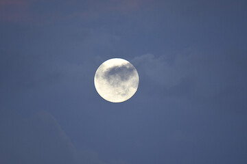 Full moon under small clouds