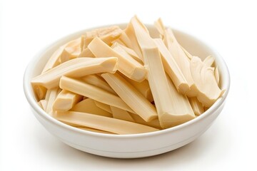 Bamboo shoot slices on a white plate set against a white backdrop an ingredient in Asian cooking