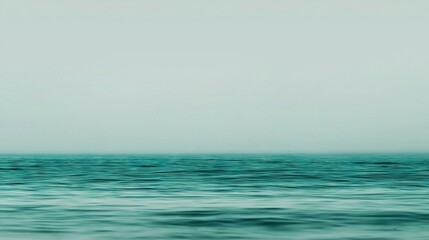 Obraz premium A solitary vessel bobbing on a vast expanse of water amidst a blurry sky