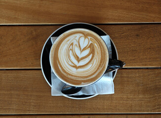 cup of coffee on wooden table
