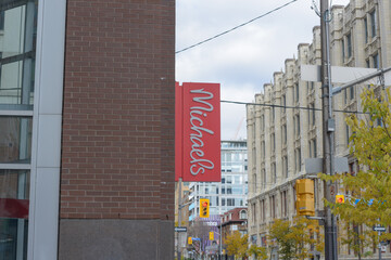 Fototapeta premium exterior buildings and sign of Michaels, a craft store chain, located here at RioCan Hall, 142 John Street in downtown Toronto, Canada